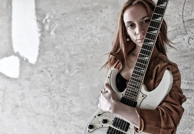 Grunge girl with electric guitar rock