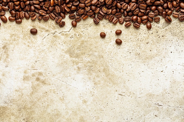 Grunge light stone wall texture with roasted coffee beans frame border