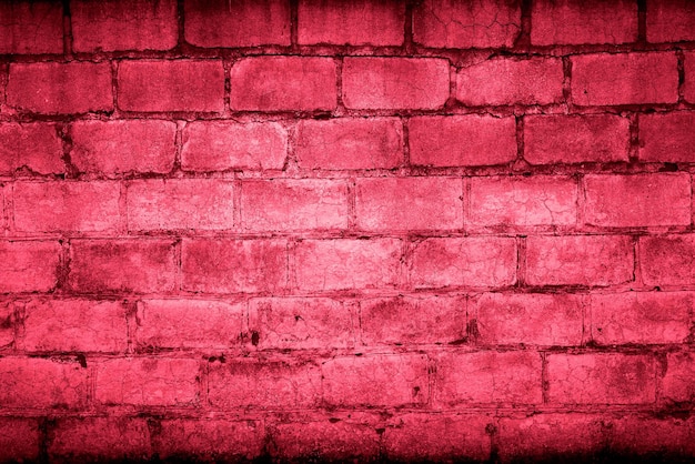 Photo grunge old brick wall as background toning in color 2023 viva magenta