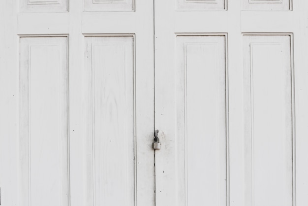 Grunge old white door with lock.