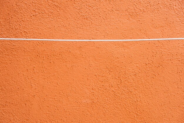 Grunge orange wall with rope