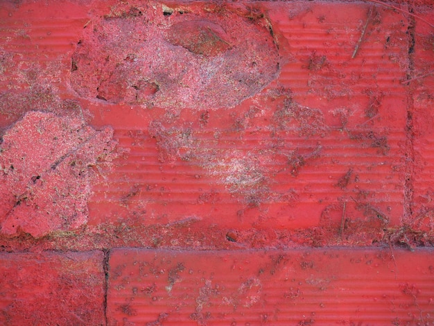 Гранж красный окрашенный фон кирпичной стены