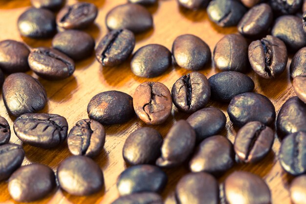 Grunge roasted coffee bean on wooden table