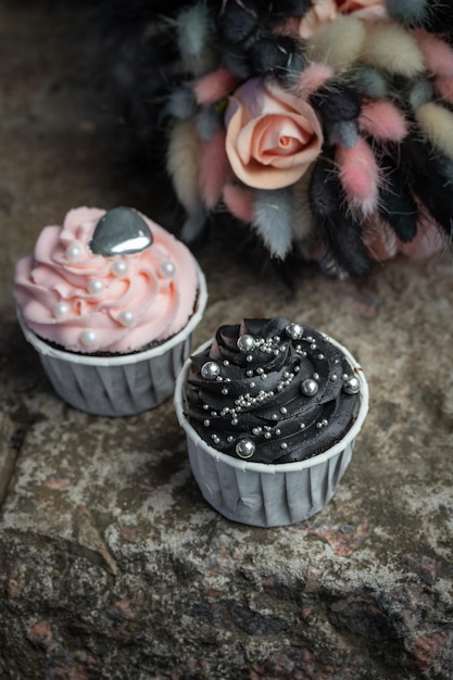 Grunge style cupcakes with black and pink cream