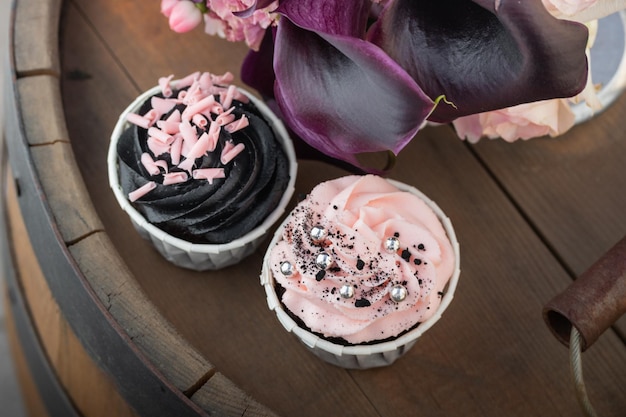 Grunge style cupcakes with black and pink cream