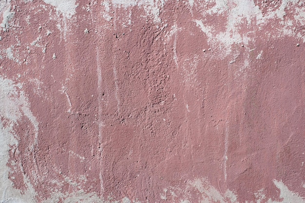 Grunge texture background red paint stain on a concrete uneven rough wall