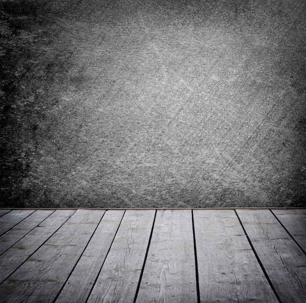 Grunge wall and wood paneled floor, interior of a room.