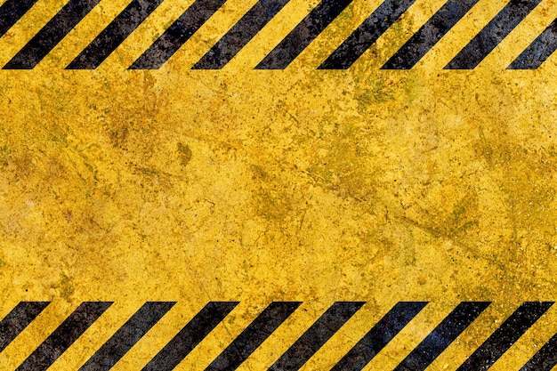 Grunge yellow and black diagonal stripes industrial warning background warn caution construction safety