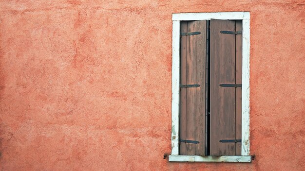 Grungy window in a red wall