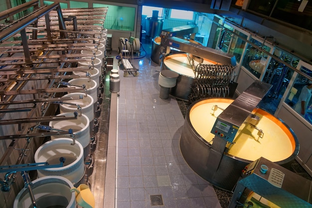 Gruyeres, Switzerland - January 2, 2015: Cheese making process. Gruyere cheese factory in the canton of Fribourg, Switzerland