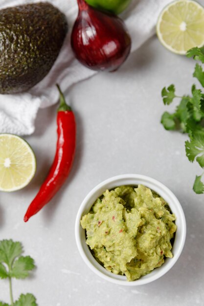 Guacamole cooking background avocado dip with ingredients for\
mexican sauce