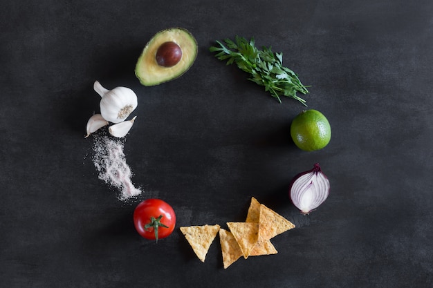 Guacamole ingredients on the dark chalkboard