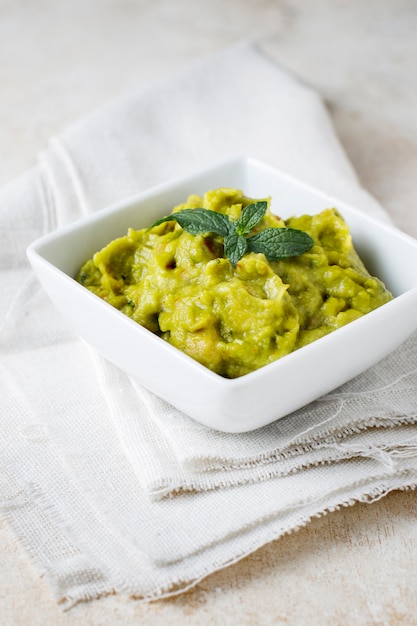 Guacamole sauce with tomato and lemon