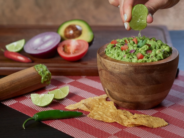 Guacamole traditional mexican food with avocado and vegetables