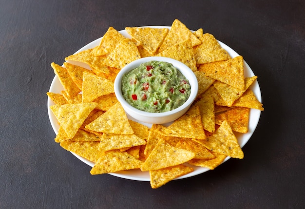 Guacamole with corn chips nachos. Mexican food. Vegetarian food.