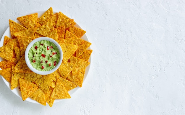 Guacamole with corn chips nachos. Mexican food. Vegetarian food.