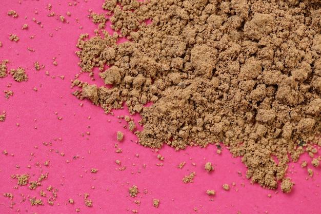 Photo guarana powder on a pink background. super food. natural energetic.