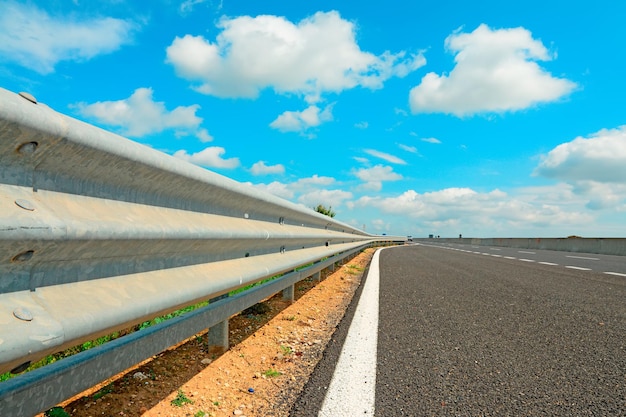 Guardrail under a cloudy sky