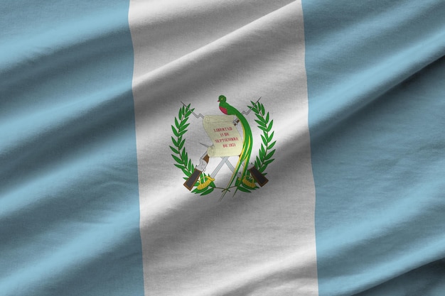 Guatemala flag with big folds waving close up under the studio light indoors The official symbols and colors in banner