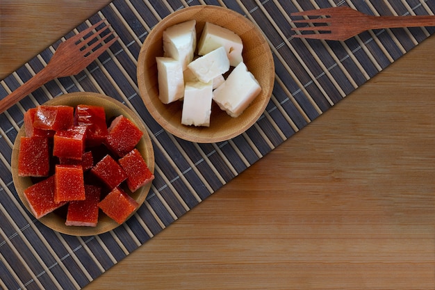 Guava candy and white cheese on wooden table  Brazilian desserts