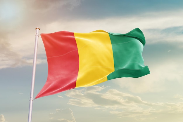 guinea national flag waving in the sky