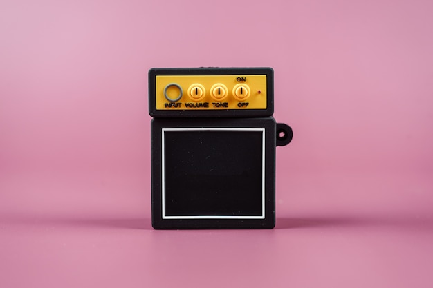 Guitar amplifier on  pink background