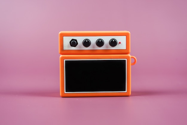 Guitar amplifier on  pink background