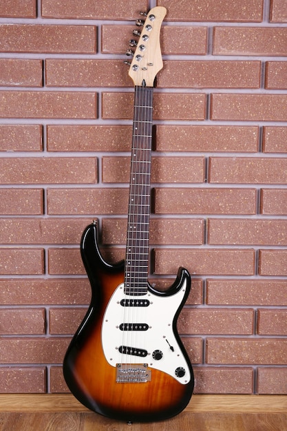 Guitar on brick wall background