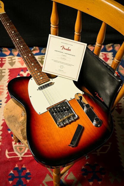 Photo guitar and card on chair stock photo