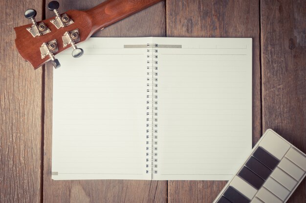 Guitar Head and mini key board on a Book for Song Writing