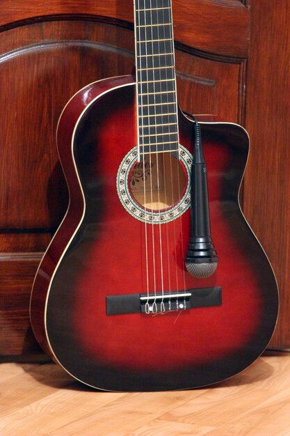 guitar and microphoneon the wooden dark background