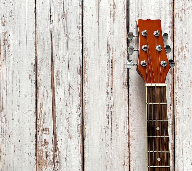 Guitar neck on a wooden background top view