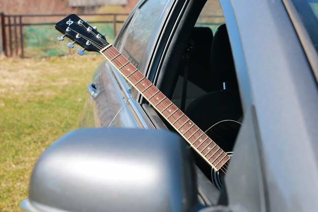 Guitar outdoor near car