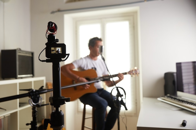 Guitar player recording at home studio