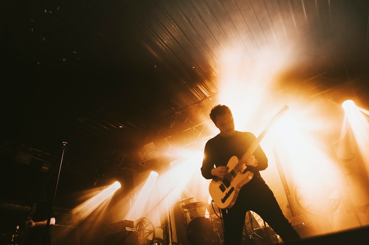 Photo guitarist playing electric guitar in a rock concert