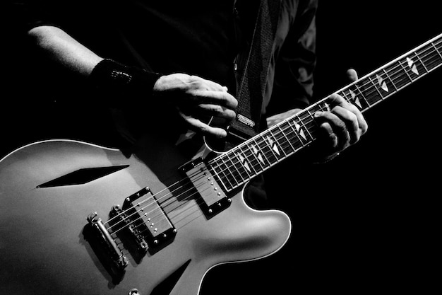 A guitarist tunes his guitar before playing in Melbourne Australia