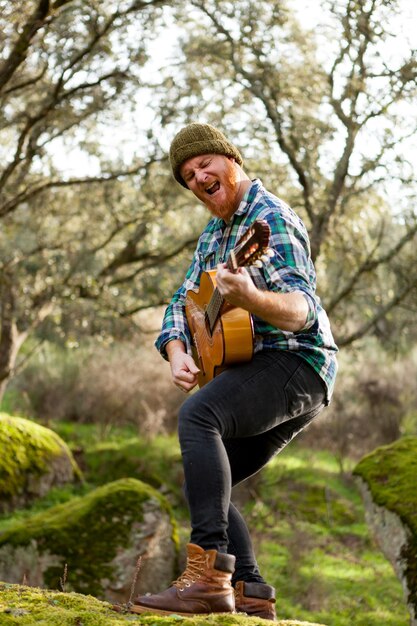 Guitarist with crazy face playing the guitar 