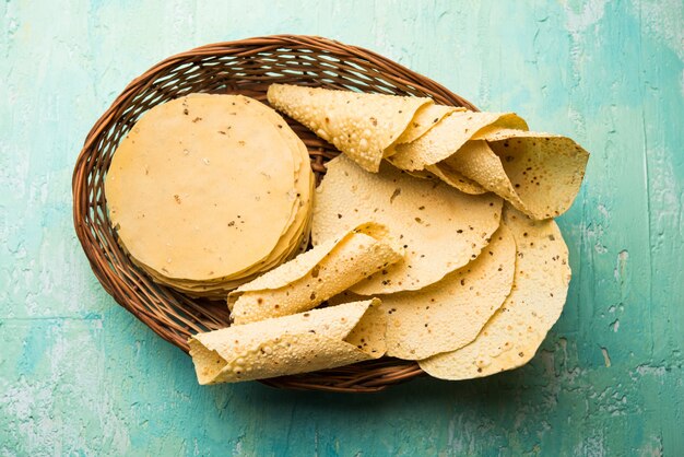 Gujarati papad or papadum in raw dried form with roasted cone, roll and flat variation