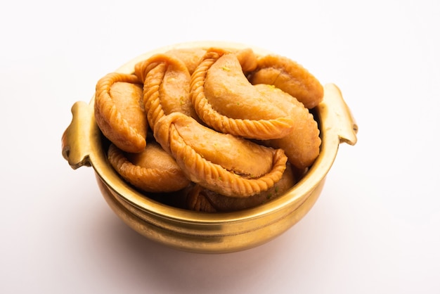 Gujiya or gujia or karanji. sweet dumplings made during the festival of holi and diwali, served in a plate