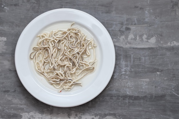 Gulas with oil on white plate.