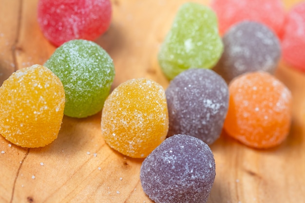 gumdrops on wooden board in macro photo with top view