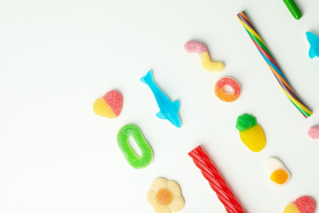 Gummy candies on white background, space for text.