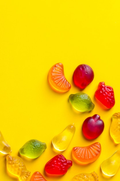 Photo gummy jelly candies in the shape of different fruits
