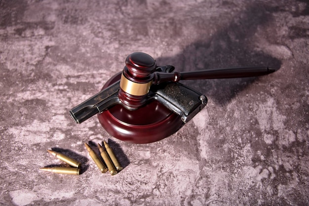 Gun under a judges gavel concept of use of arms and justice