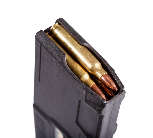 Gun magazin with ammo isolate on white. Macro photo