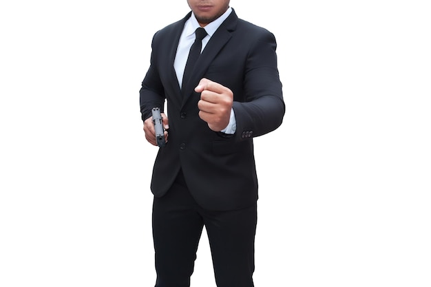 A gunman in a black suit holds a pistol with his other hand up to cover the target. isolated white background Concept of assassination, murder, criminal, bandit