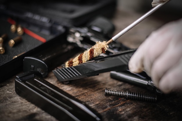 The gunsmith is sitting around cleaning the gun and\
disassembling and maintaining the pistol