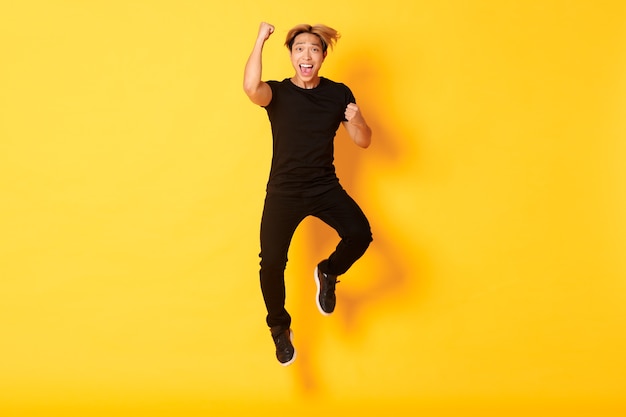 guy in black clothes jumping and celebrating victory