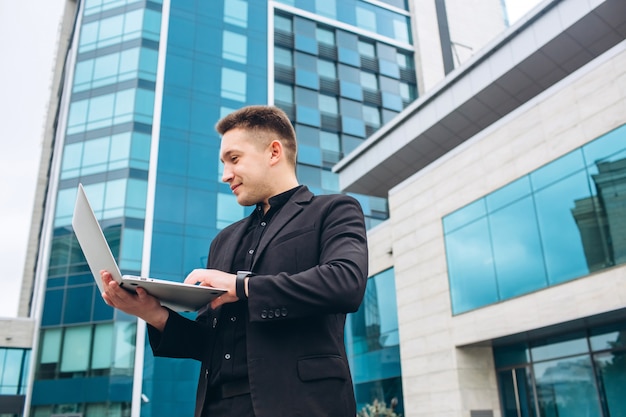 The guy in the black suit of the glass modern business center.