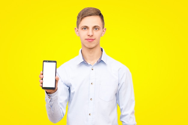 The guy in the blue shirt advertises the phone isolated on a yellow background